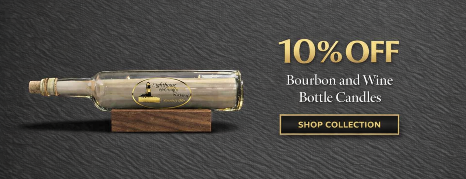 A horizontal wine bottle candle with a lighthouse logo resting on a wooden stand, set against a dark textured background with gold text reading "10% OFF Bourbon and Wine Bottle Candles, SHOP COLLECTION".