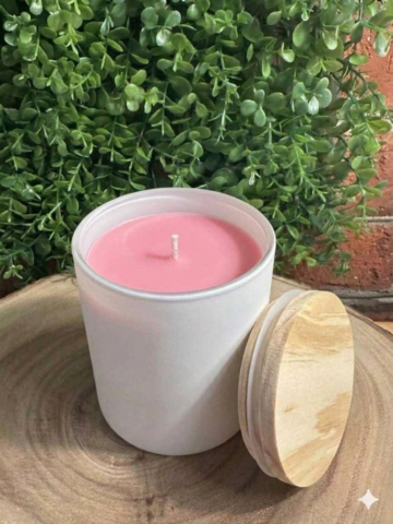 almond vanilla candle in a white ceramic vessel with pink wax — front view