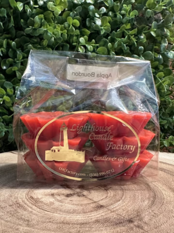 Apple Bourbon Wax Tarts with Chili Red wax in a clear bag with gold oval branding