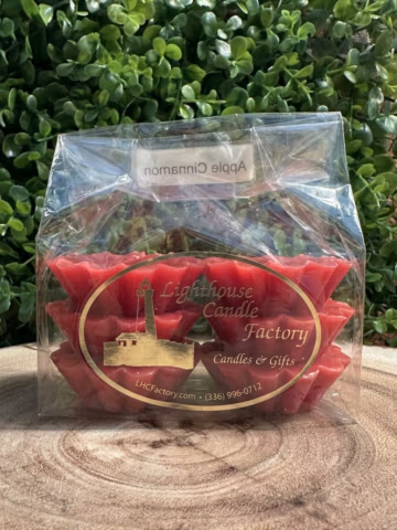 Apple Cinnamon Tarts with crimson red wax in fluted tart shapes, packaged in a clear bag
