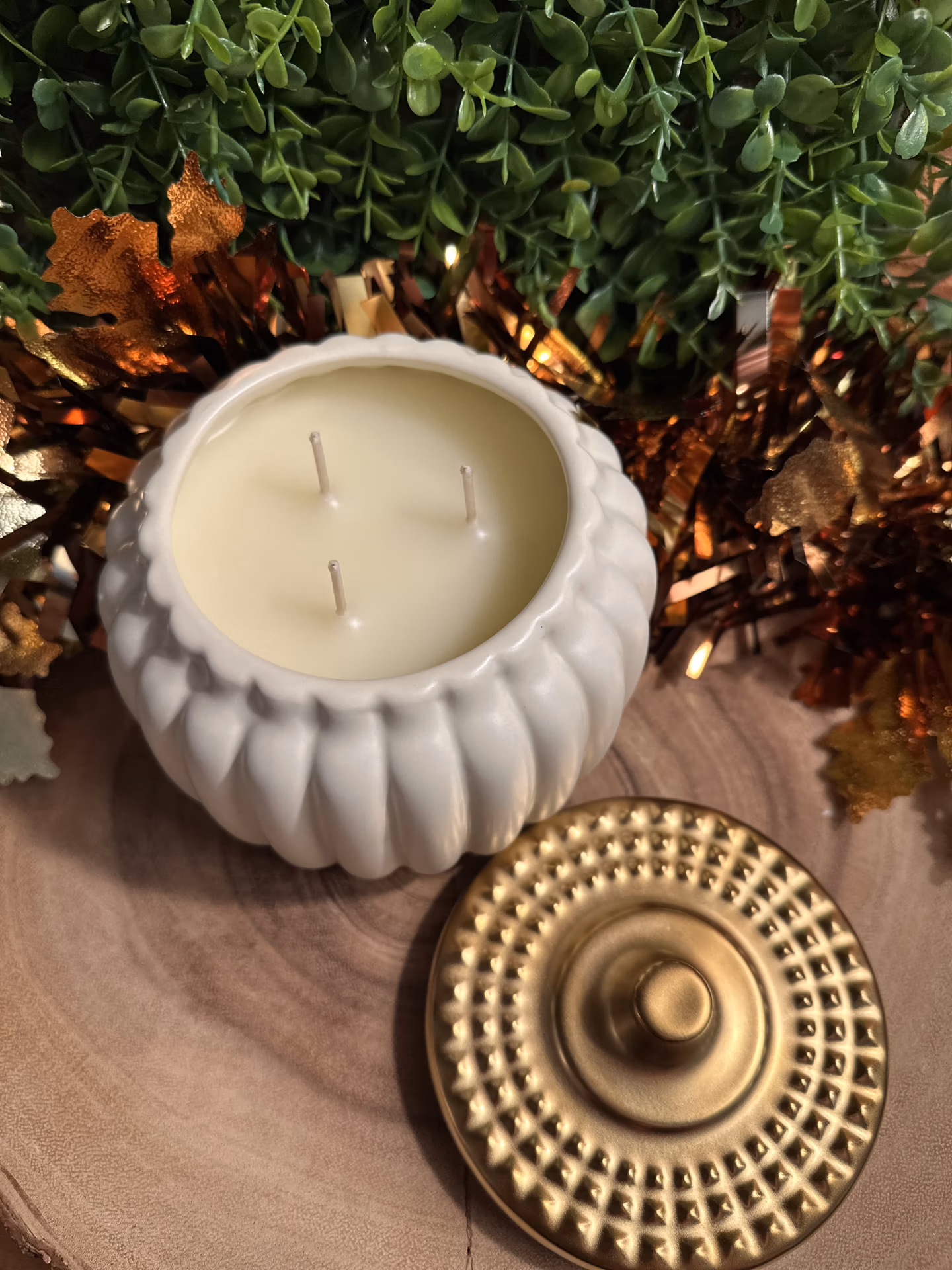 grandpas_apple_cider_18oz_ivory_pumpkin_jar_overhead Grandpa's Apple Cider Candle in a ivory pumpkin-shaped jar with three unlit wicks and a gold lid beside it