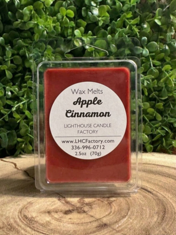 Apple Cinnamon Wax Melts with crimson red wax in a clear clamshell tray with a round white label