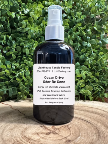8 oz. Ocean Drive Odor Be Gone (OBG) all-purpose fragrance spray by The Lighthouse Candle Factory in a dark bottle with a white fine mist sprayer.