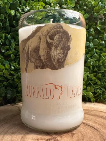 Front view of a recycled Buffalo Trace bourbon bottle candle filled with premium scented wax from The Lighthouse Candle Factory.