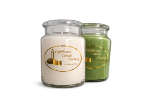 Two signature glass jar handmade candles from Kernersville, NC, featuring a white candle with a gold Lighthouse Candle Factory logo label and a green Odor Be Gone technology jar candle, curated for a professional scented candle blog.