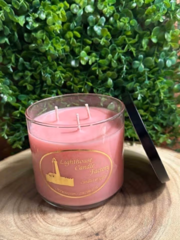 almond vanilla candle in a clear vessel with pink wax — front view