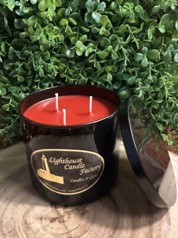 Apple Bourbon Candle in a black vessel with chili red wax — front view