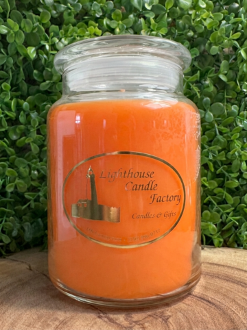Pumpkin Pie scented candle with Pumpkin Orange wax, clear lid fitted and front label facing forward.